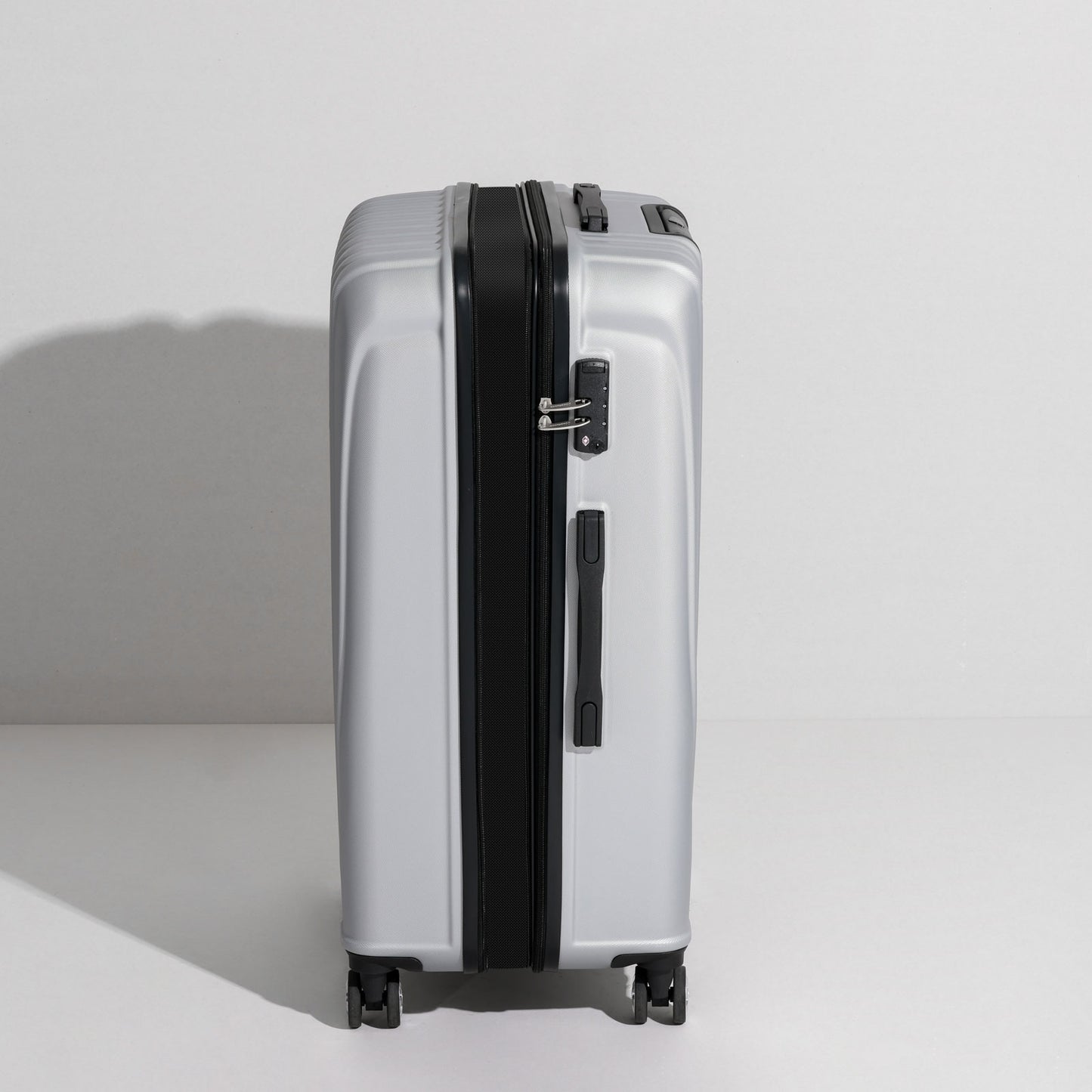 uiimiii silver large check-in luggage side